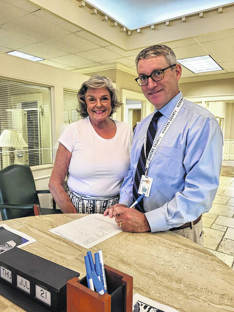 President of Pickens Rotary Club Ken Roper, right, and Jeannie Gilstrap, left, fill out the bank paperwork to wire the funds to Ukraine.
Courtesy photo