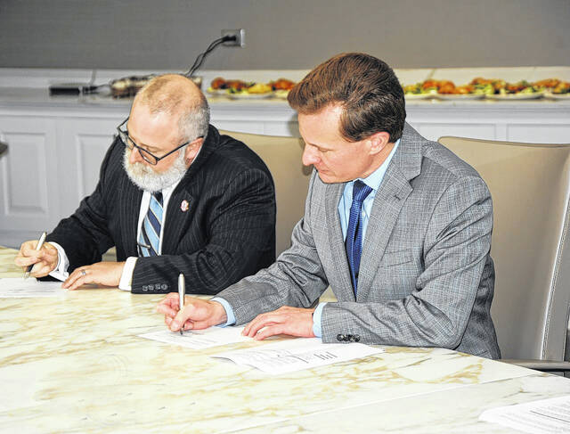 North Greenville University Provost Nathan Finn (left) and Tri-County Technical College President Galen DeHay (right) sign the agreement.
Courtesy photo