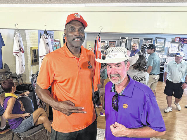 Easleys Jeff McAlister (right) gets his picture taken with Clemson University legend and NBA star Anthony Davis on Sunday during the auction during the Orange and White Weekend. McAlister is a die-hard fan of the Clemson Tigers and a big supporter of their sports programs.
Jeff Holt | The Easley Progress