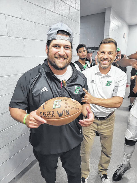 Easley High School Principal Josh Oxendine awards Sam Houston a game ball in honor of his first win for the Green Wave football team. EHS rolled to a 41-14 win over Wade Hampton.
                                 Photo Submitted