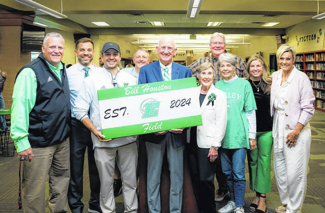 Bill Houston (center) is pictured during a dedication ceremony last Friday night before having the Easley High School football field named after him.
Scott Schroeder | The Easley Progress