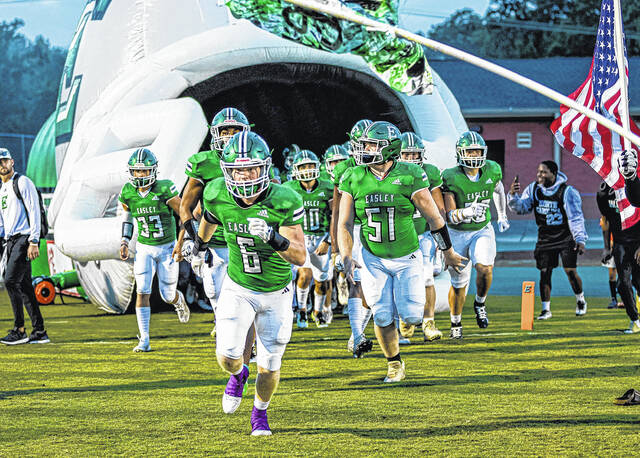 Pictured is the Easley High School football team taking the field earlier this season. The Green Wave will travel to play T.L. Hanna on Friday night. Senior Kadin Davis (6) and sophomore Cole Watkins (51) help lead the way. 
                                 Scott Schroeder | The Easley Progress