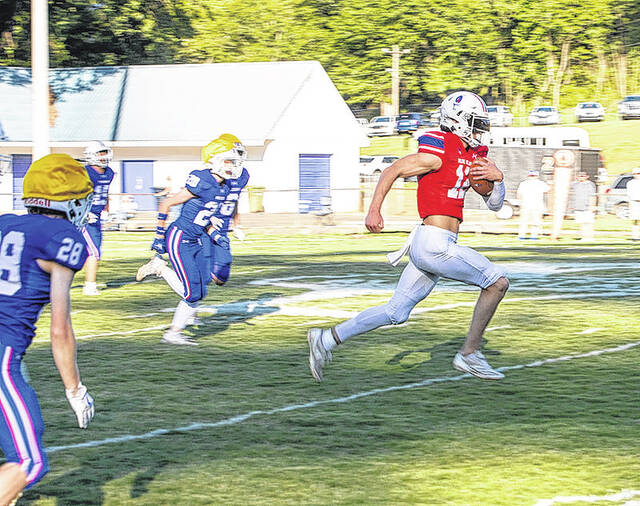 Pictured is Pickens High School quarterback Brooks Dow scrambling for some yardage during a recent scrimmage. Dow, a 6-foot-5 quarterback, returns to lead the Blue Flame offense this season.
                                 Mark Beery | For The Progress