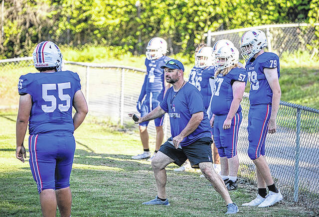 Pickens Offensive Line Coach Kyle Bishop works with his players during a recent scrimmage. Bishop, a graduate of Berea High School, walked on at the University of South Carolina when Lou Holtz was coaching. 
                                 Mark Beery | For The Progress
