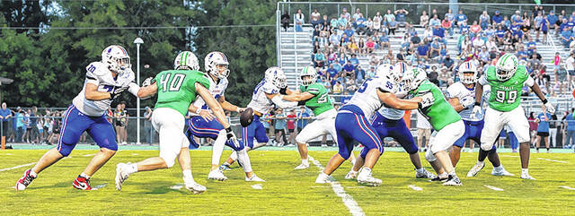 Pickens junior QB Brooks Dow (No. 12) looks for room to either throw or pass on Friday night in a 56-34 loss to host Easley. Dow still had over 350 combined yards of passing and rushing.
Mark Beery | For The Progress