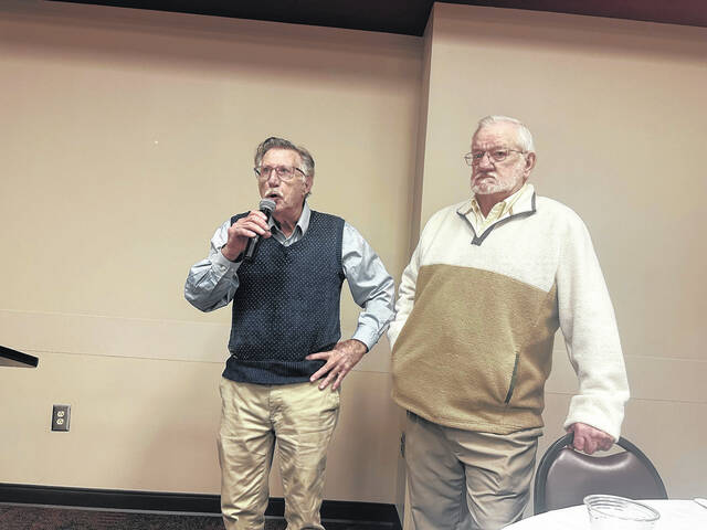 Pictured is former Easley High School track coach David Loggins telling a story about Green Wave legend Stanley Morgan on Friday night at a football dinner for the Larry Bagwell era (1967-72). Also pictured is Coach Keith Godfrey who helped put on the event.
                                 Jeff Holt | The Easley Progress
