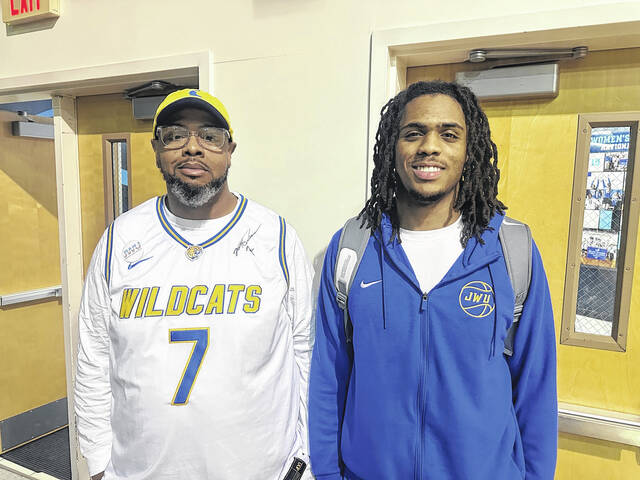 Pictured is Easley High School grad Jakobe Ginns (right) with his dad, Lamar, after a recent game in Greenville. Ginns plays basketball for Johnson & Wales University and they recently fell to Bob Jones University 84-72.
                                 Jeff Holt | The Easley Progress