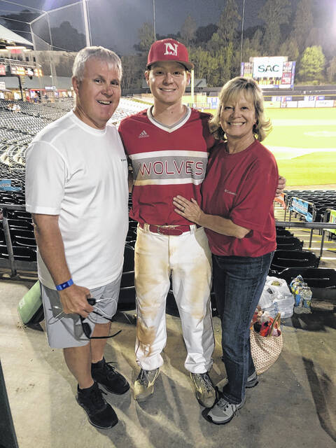 Pictured are Todd and his wife (Kim) with their son (Ben) at a game.
Photo Submitted