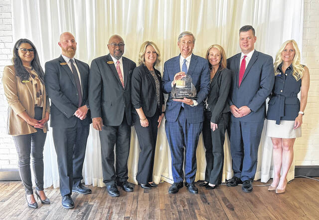 Pictured is Chris Robinson (holding the plaque) and his team from Robinson Funeral Home being honored for the Business of the Year last week at the 78th Annual Meeting Awards Luncheon. Truliant Federal Credit Union presented the award.
                                 Photo Submitted