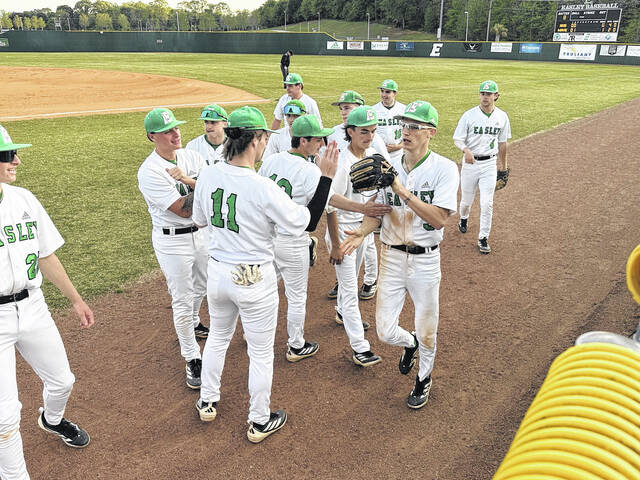 Easley centerfielder Trey Kicklighter is congratulated by his teammates after making one of the best catches of the season last week against Hillcrest. Kicklghter is a senior for the Green Wave.
Jeff Holt / The Easley Progress
