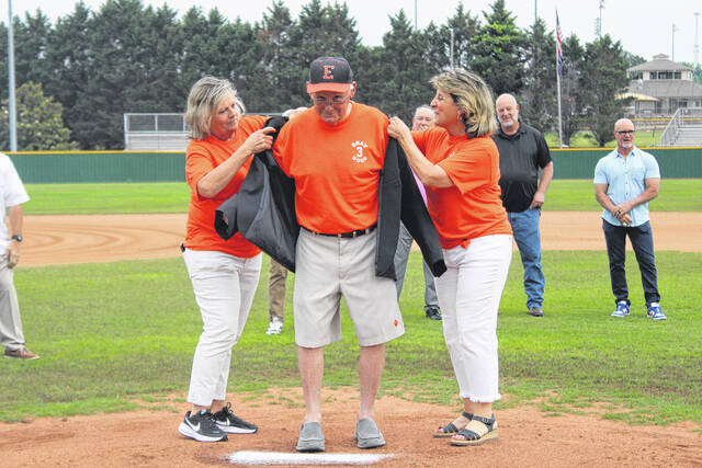 Former Post 52 Bat Girls Julie Ellison and Carol Jo Baumgardner help put the jacket on legendary coach Randy Bray on Friday night during the pregame ceremony at Gregg Powell Field.
Jeff Holt / The Easley Progress