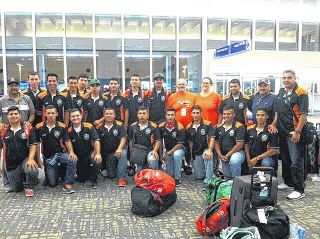 Pictured are Tim and Hester Elro (orange shirts in back row) with one of the teams that they have hosted in the past for the Senior League World Series in Easley.
                                 Courtesy photo