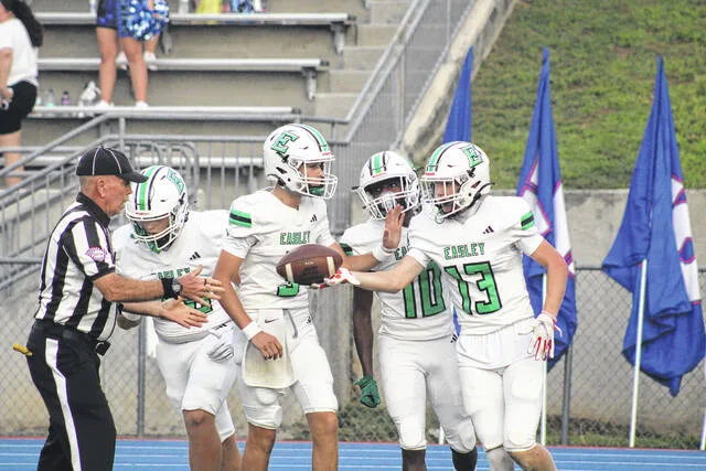 Easley sophomore Chase Wimpey (No. 13) celebrates in the end zone with his Green Wave teammates (Whit Rodgers and Jay Payton).
Jeff Holt / The Easley Progress